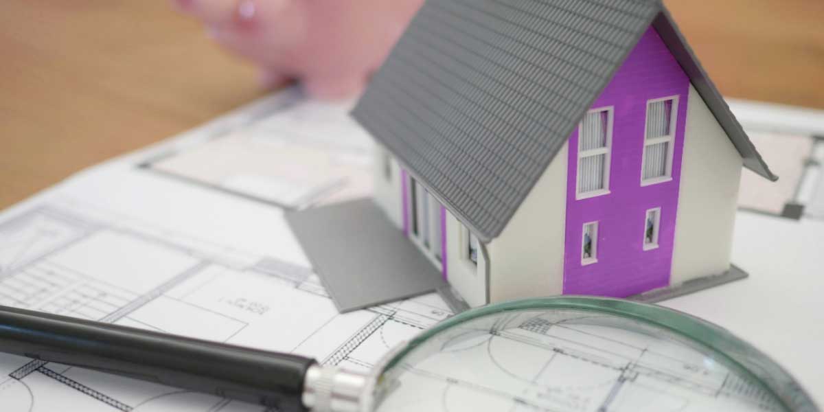 evaluating-your-inherited-property a magnifying glass and a little pink house piece to show the thinking behind Legal and Financial Considerations